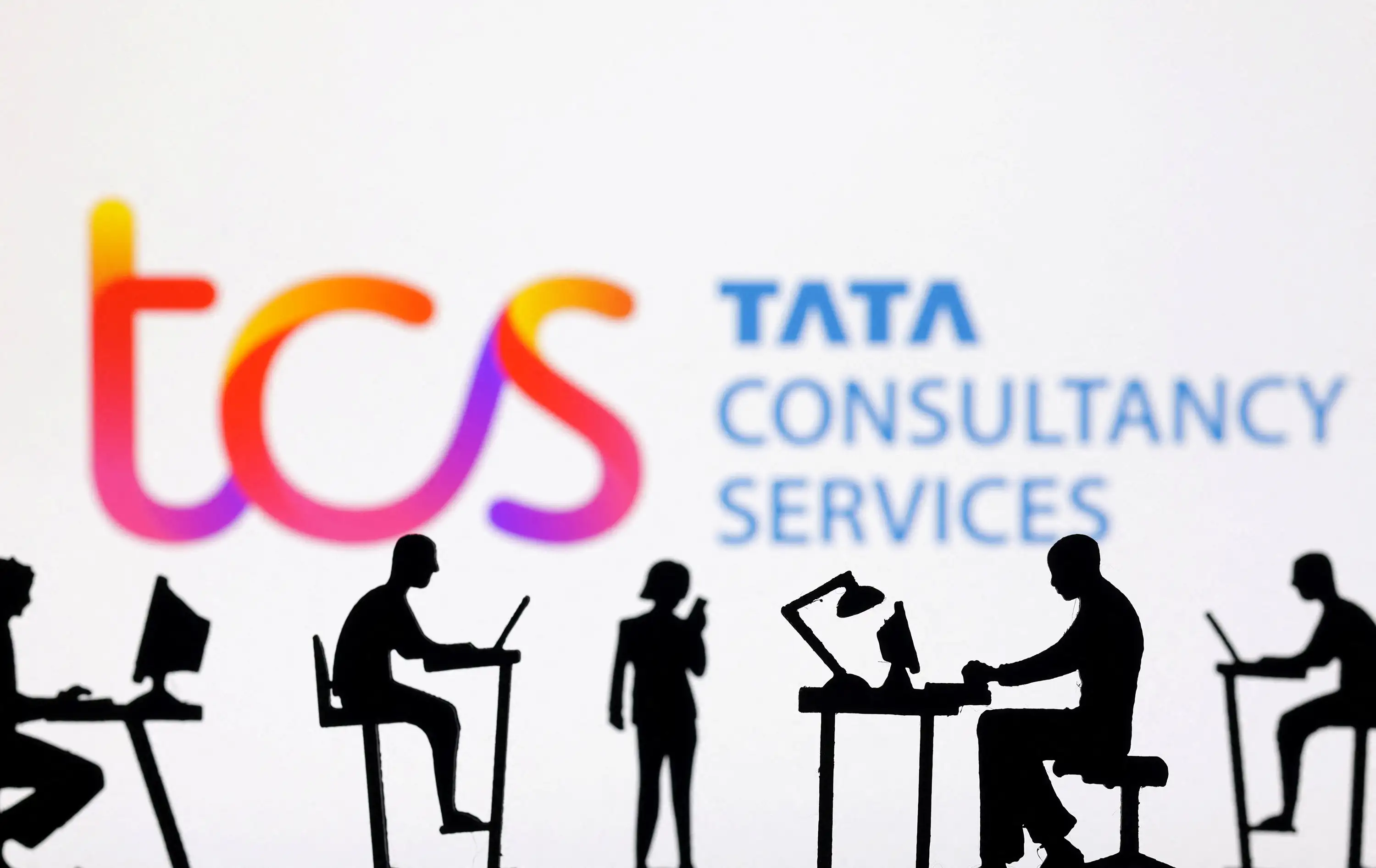 Figurines with computers and smartphones are seen in front of TCS: Tata Consultancy Services logo in this illustration taken, February 19, 2024.